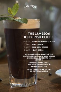 the jamesonn iced irish coffee is served in a tall glass with a mint sprig on top