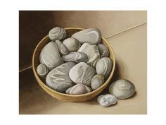 a painting of rocks in a bowl on the ground next to some other rocks and pebbles