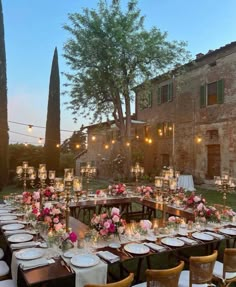 an outdoor dining area with tables and chairs set up for a formal dinner in the evening