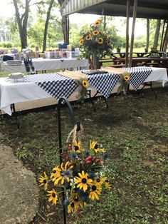 sunflowers and other flowers are on the tables