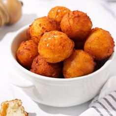 a white bowl filled with fried food on top of a table