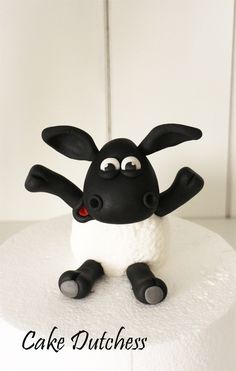 a cake with a black and white sheep on it