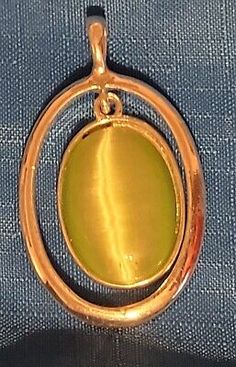 a gold pendant with a circular design on it