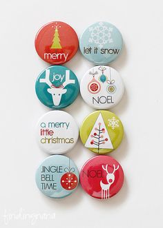 six christmas buttons are arranged on a white surface with the words merry and nola