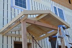 a wooden structure being built in front of a building