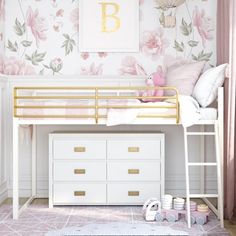 a white bunk bed with pink flowers on the wall next to a dresser and rug