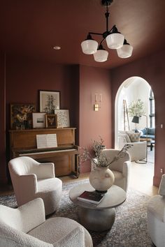 a living room filled with furniture and a piano