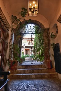 an entrance to a building with plants growing on it