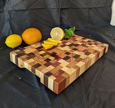 a wooden cutting board with lemons and spinach on it