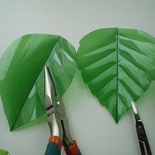 scissors and some paper leaves on a table