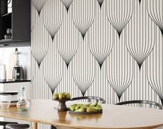 a kitchen with black and white wallpaper and wooden table in front of the counter