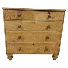 an old wooden chest of drawers with knobs on the top and bottom, against a white background