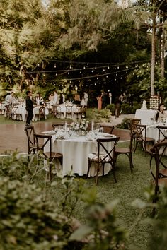 an outdoor wedding reception with tables and chairs