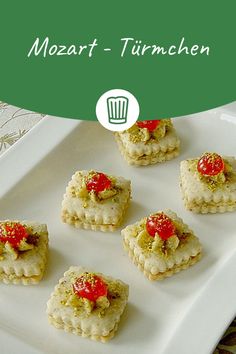 small appetizers are arranged on a white plate with a green border around it