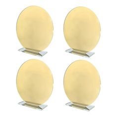 four yellow round plates sitting on top of each other in front of a white background