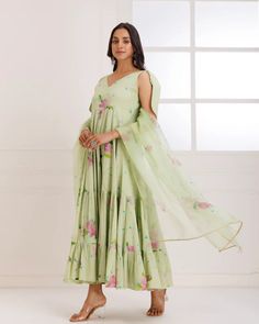 This is a 2 piece set. A simple yet alluring Pista Green Mul Mul Hand Painted Tier Suit Set with Dupatta is best for any occasion. The set comes with hand painted anarkali kurta with tie up detailing has calf length, sleeveless and v neck teamed and an organza dupatta with lace and tassels in the corner. No of Sets - 2 Color - Green Kurta Fabric – Mul Mul Work – Hand Painted Work. Sleeves-Tie up detailing Slits - No Slits Length - Calf Length Dupatta – Organza dupatta with lace & tassels detailing CARE: Gentle Hand Wash DISCLAIMER - The color of the product may be differ due to screen settings of device. Festive Green V-neck Sets, Green Anarkali Set With V-neck, Fitted Green Floral Print Palazzo Set, Fitted V-neck Anarkali Sets, Sleeveless Green Floral Print Set, Georgette V-neck Sets With Dupatta, Pista Green Anarkali Dress With Floral Print, Anarkali Sets In Pista Green For Spring, Spring Georgette Sets With Floral Print