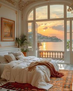 a bedroom with a large window overlooking the water