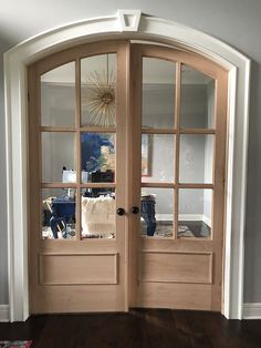 a wooden door with two glass panels on the front and side doors to both sides