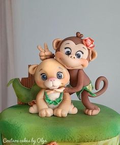 there is a cake that has a monkey on top of it and another monkey on the bottom