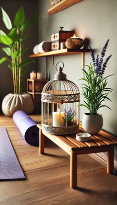 a wooden table topped with a birdcage filled with candles next to a yoga mat