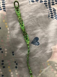 a close up of a green rope on a bed