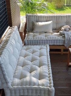 two couches and a coffee table on a deck