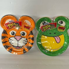 two paper plates with different designs on them, one has a tiger and the other has a frog