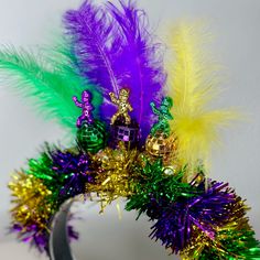 there is a headpiece made out of tinsel and feathers on top of it