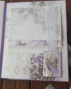 an open book with lace and flowers on it