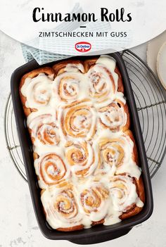 cinnamon rolls in a baking pan on a cooling rack with the title text overlay