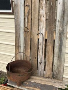 an old bucket sitting on top of a wooden bench