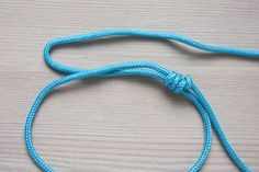 a close up of a blue rope on a wooden surface