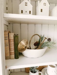 a white shelf filled with books and other items