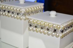 two white boxes with pearls and crystals on them