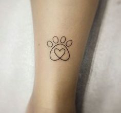 a small paw and heart tattoo on the ankle