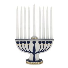 a white and blue menorah with eight candles on it's stand, in front of a white background