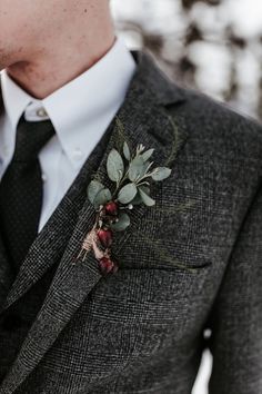 a man in a suit with a boutonniere on his lapel