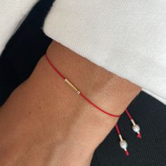 Delicate red string wish bracelet decorated with  freshwater pearls on string ends.  String has an adjustable clasp. It's a perfect small dainty gift for everyone.  It looks very delicate and its good to wearing everyday.  Details : * Sterling silver or 24K gold vermeil details; * Silk string: * Strong adjustable clasp 🎁 READY AS A GIFT! GIFT MESSAGE AVAILABLE (please write the message in the comments field)  It comes with beautiful packaging box. Dainty Red Friendship Bracelet Gift, Dainty Adjustable Red Bracelet, Red Minimalist Bracelets With Adjustable Cord, Minimalist Red Resizable Bracelet, Red Thread Bracelet, Bracelet With Pearls, Hand Chain Jewelry, Thread Bracelet, Summer Bracelet