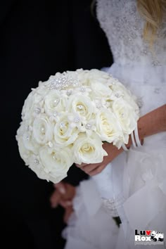 a close up of a person holding a wedding bouquet