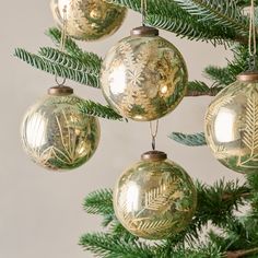 gold ornaments hanging from a christmas tree