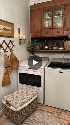 a white washer and dryer sitting in a kitchen next to a brick floor