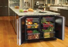 an open refrigerator with food inside on top of a wooden floor in a kitchen next to a counter