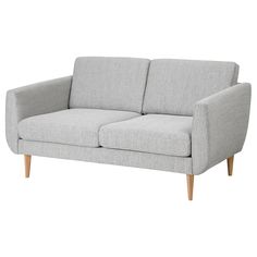 a light gray couch sitting on top of a white floor next to a wooden frame