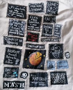 a bunch of patches with words written on them and some writing on the back of them