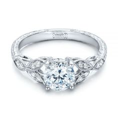 a white gold engagement ring with an intricate design