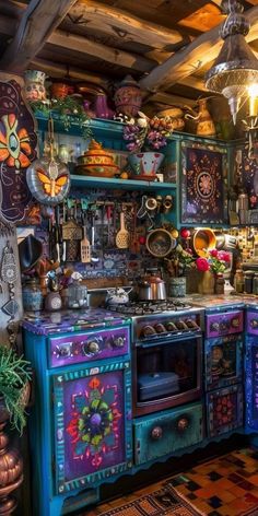 an old fashioned kitchen with colorful painted cabinets