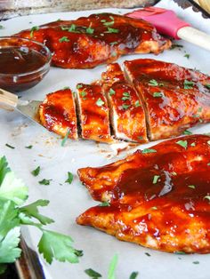 bbq chicken wings with sauce and garnishes on the side, ready to be eaten