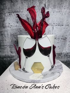 there is a cake with wine glasses on it