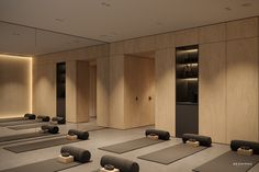 there are many yoga mats lined up in the room with lights on each side of them