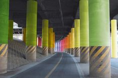 an empty road with multiple colored columns on both sides